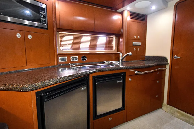 Pure Fun Yacht Photos Pics Luxurious kitchen interior of 2007 Sea Ray 40 Sundancer yacht with modern appliances.