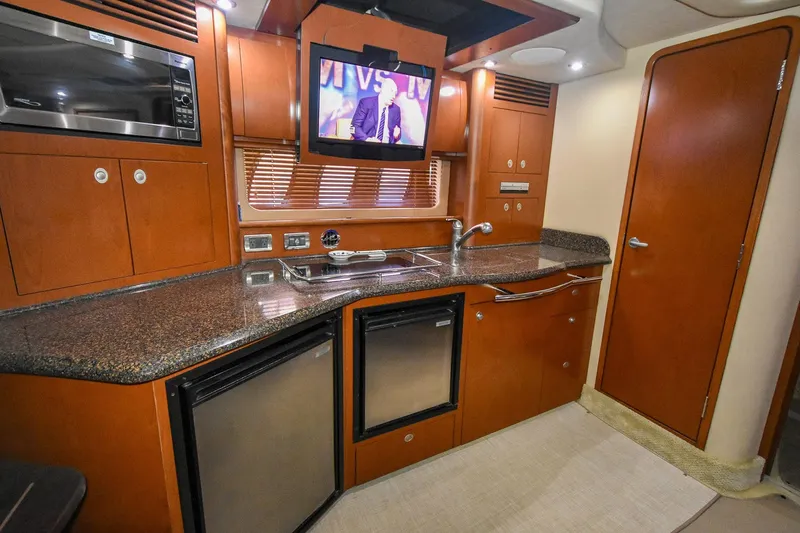 Pure Fun Yacht Photos Pics Luxurious 2007 Sea Ray 40 Sundancer yacht kitchen with modern appliances and sleek wood cabinetry.