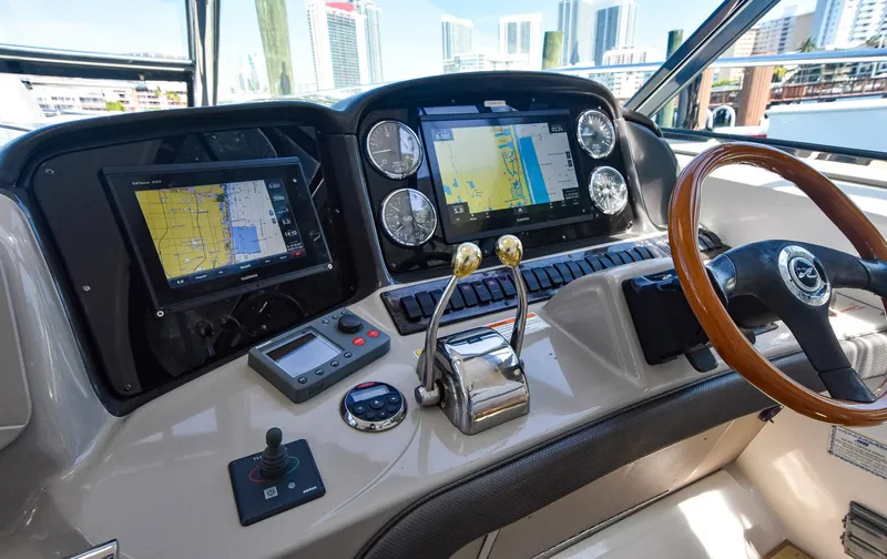 Pure Fun Yacht Photos Pics Helm of 2007 Sea Ray 40 Sundancer with navigation screens and controls.