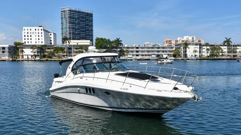 Pure Fun Yacht Photos Pics 2007 Sea Ray 40 Sundancer yacht cruising in a scenic urban waterfront setting.