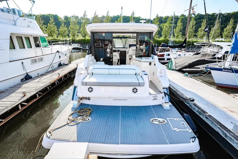  Yacht Photos Pics 2021 Regal 36 Grande Coupe yacht docked at marina, rear view.
