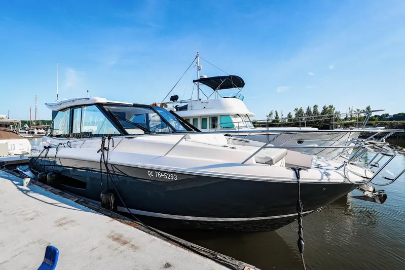  Yacht Photos Pics 2021 Regal 36 Grande Coupe docked at marina under clear blue sky.