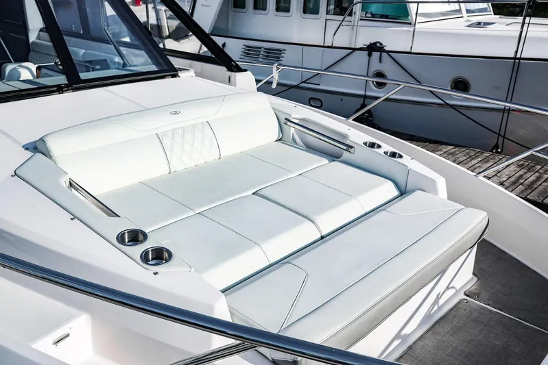  Yacht Photos Pics Luxurious seating on 2021 Regal 36 Grande Coupe yacht, featuring sleek white upholstery.