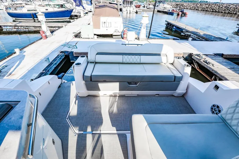  Yacht Photos Pics 2021 Regal 36 Grande Coupe boat interior with seating at a marina dock.