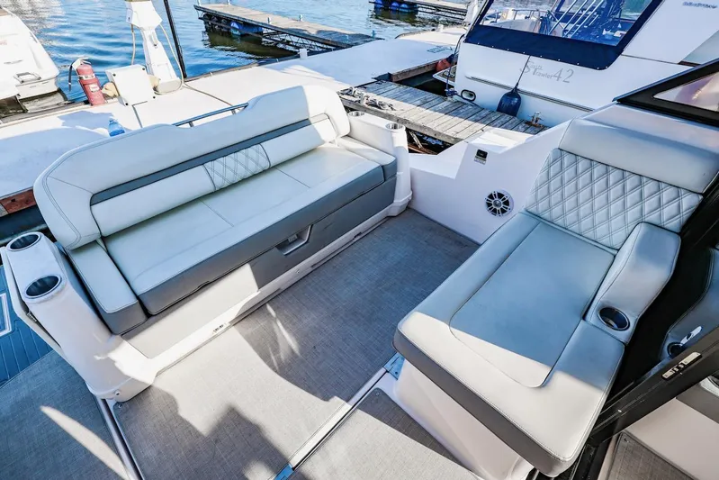  Yacht Photos Pics Luxurious seating area on a 2021 Regal 36 Grande Coupe yacht at a marina.