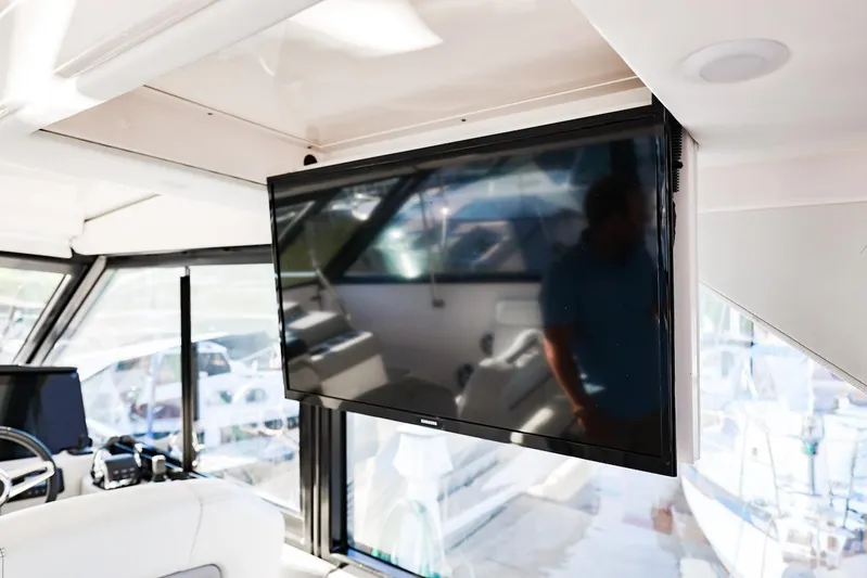  Yacht Photos Pics Interior of 2021 Regal 36 Grande Coupe with mounted TV screen.