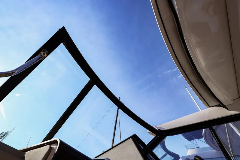  Yacht Photos Pics 2021 Regal 36 Grande Coupe boat with open glass roof against blue sky.