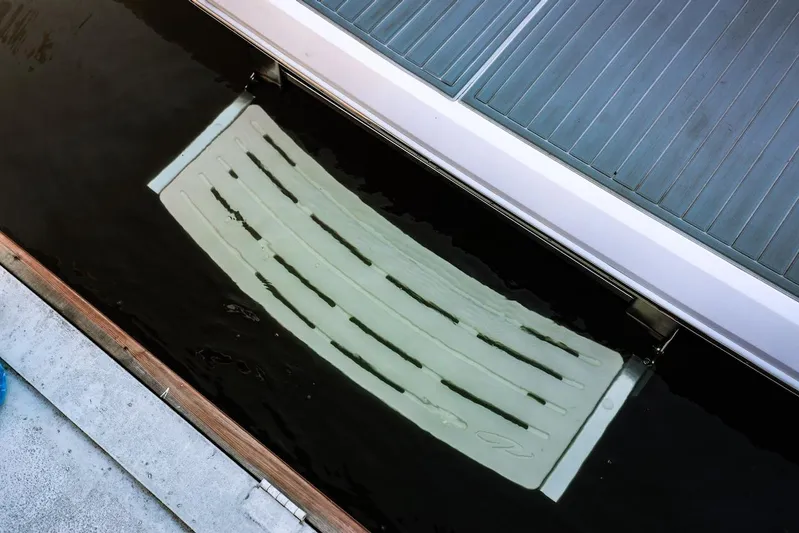  Yacht Photos Pics 2021 Regal 36 Grande Coupe swim platform partially submerged in water.