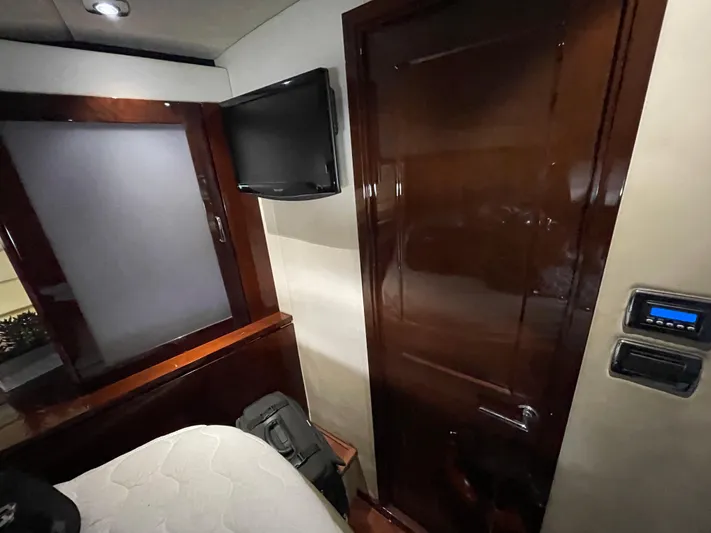  Yacht Photos Pics Interior cabin of 2010 Sea Ray 540 Sundancer with TV and wooden door.