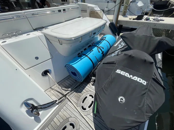  Yacht Photos Pics 2010 Sea Ray 540 Sundancer yacht with Sea-Doo jet skis and blue mat on deck.