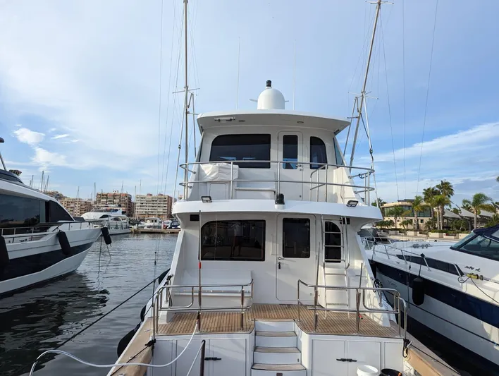  Yacht Photos Pics 2001 Hatteras 70 Convertible yacht docked at a marina.