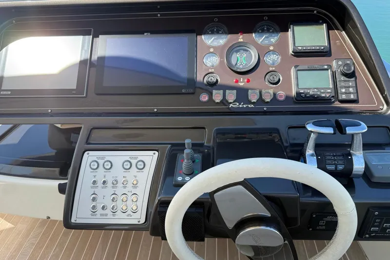  Yacht Photos Pics Control panel of 2013 Riva 75 Venere Super yacht with steering wheel and navigation instruments.