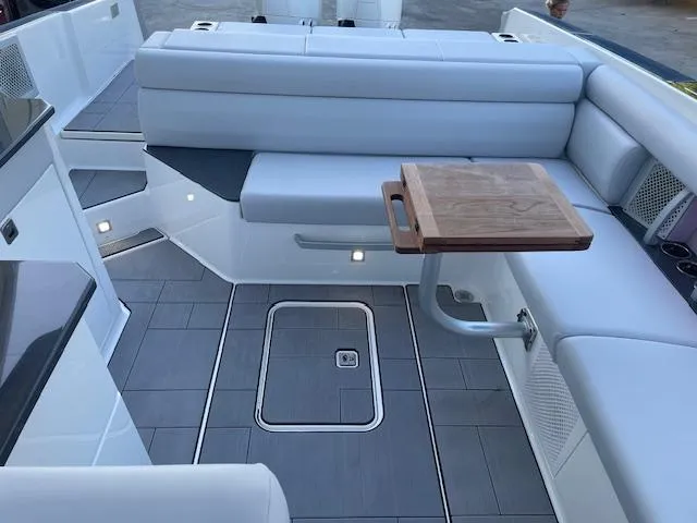  Yacht Photos Pics 2022 Aviara AV 32-OB boat interior with sleek seating and wooden table.