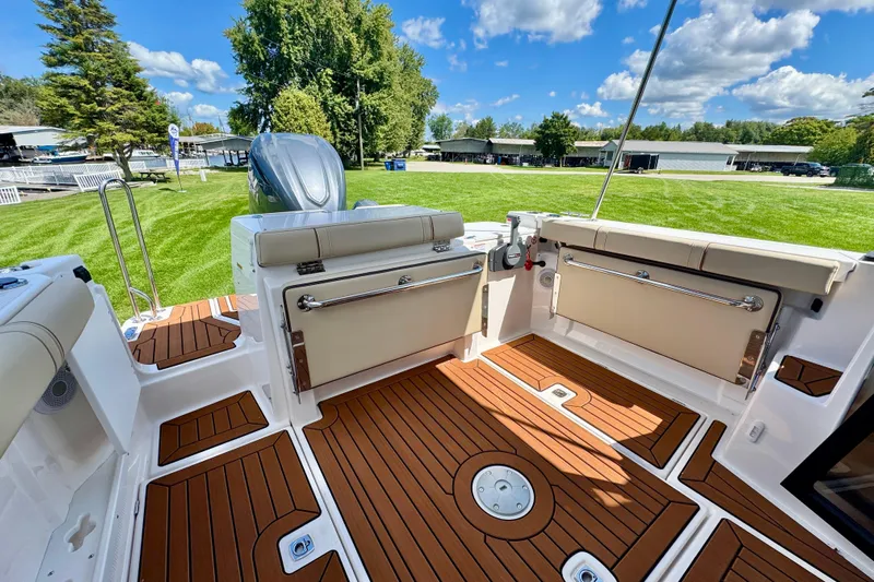  Yacht Photos Pics 2025 Ranger Tugs R-27 boat interior with teak flooring and outdoor seating.