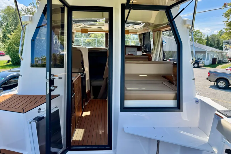  Yacht Photos Pics 2025 Ranger Tugs R-27 interior view with open doors and seating area.