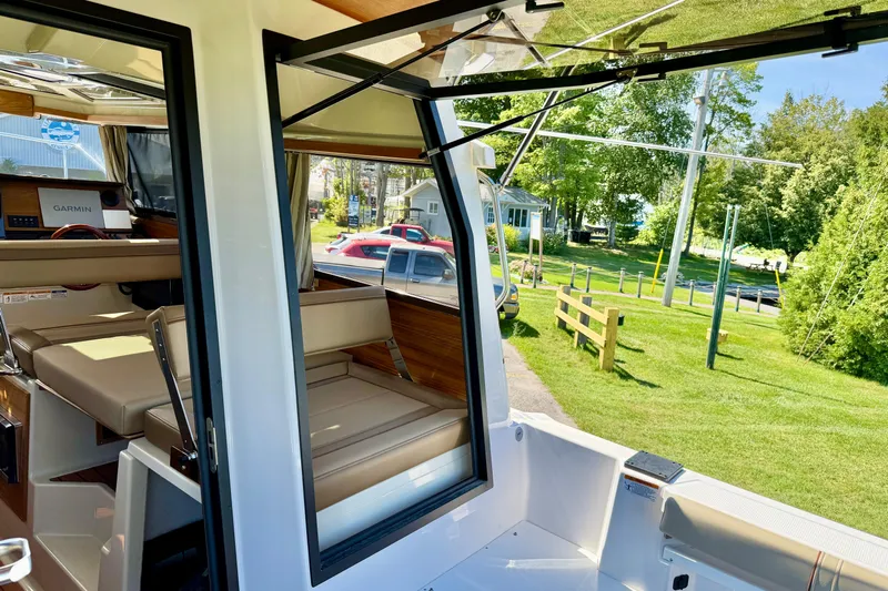  Yacht Photos Pics 2025 Ranger Tugs R-27 interior view with seating and Garmin navigation system.