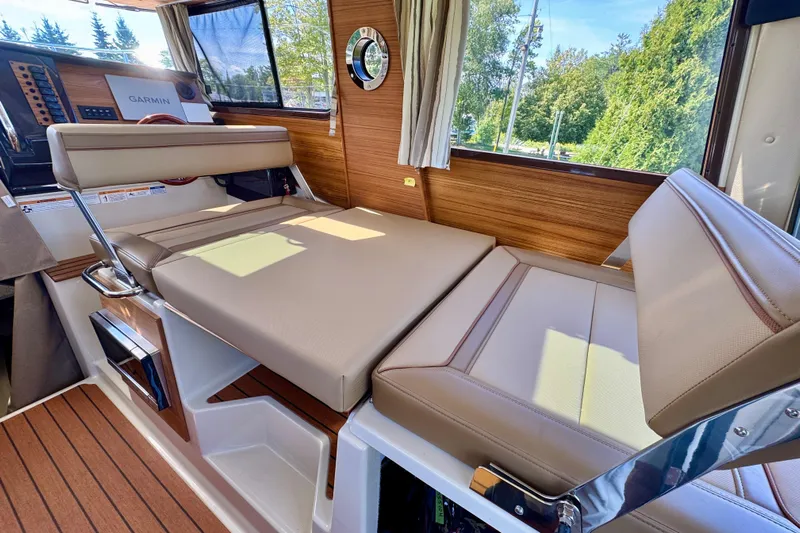  Yacht Photos Pics Interior of 2025 Ranger Tugs R-27 with beige seating and wood accents.
