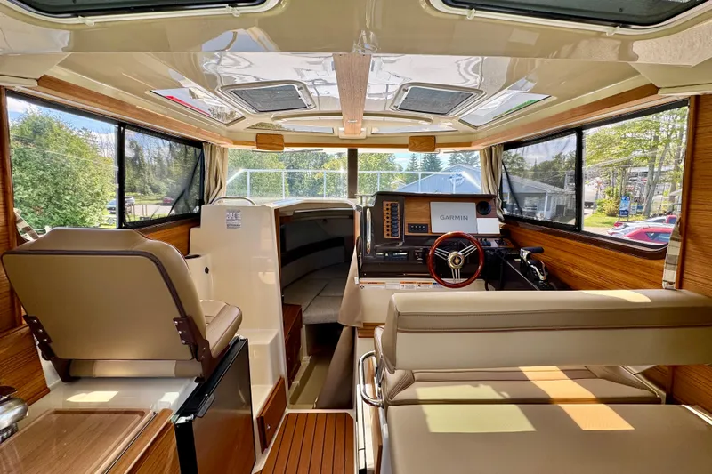  Yacht Photos Pics Interior of 2025 Ranger Tugs R-27 boat with modern helm and seating.