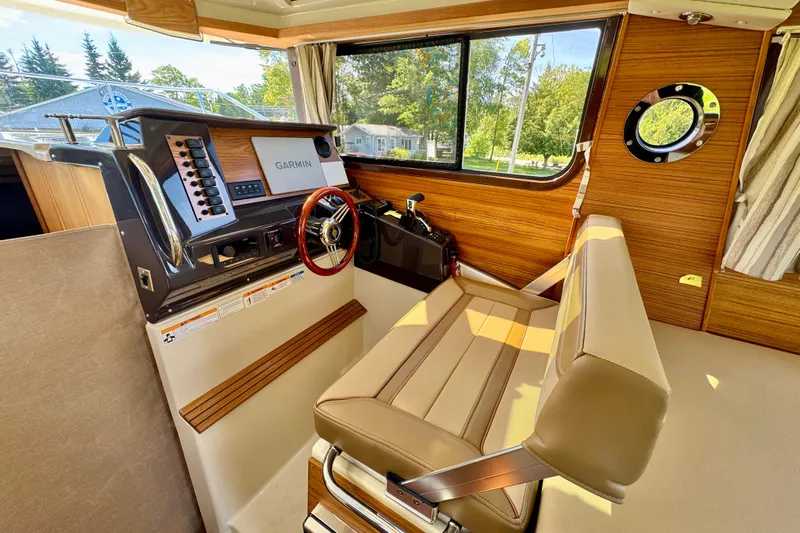  Yacht Photos Pics Interior of 2025 Ranger Tugs R-27 boat with Garmin navigation system and wood accents.