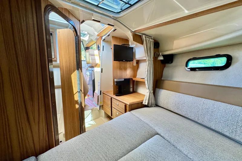  Yacht Photos Pics 2025 Ranger Tugs R-27 interior cabin with cozy seating, wood accents, and natural light.