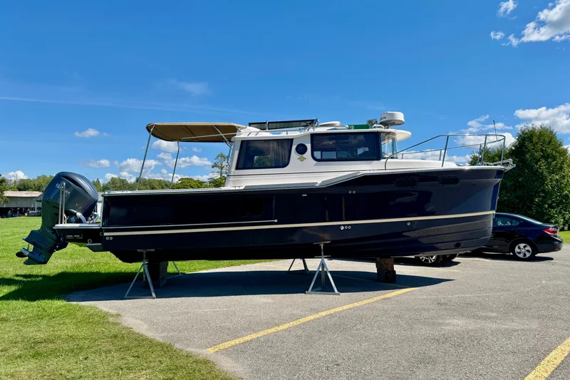  Yacht Photos Pics 2025 Ranger Tugs R-27 boat on display under clear blue sky.