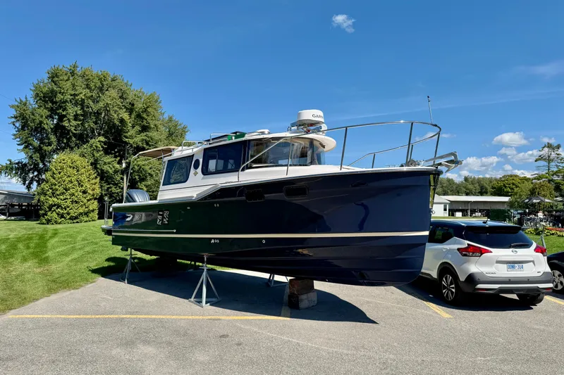  Yacht Photos Pics 2025 Ranger Tugs R-27 boat on display in a parking lot, sunny day.