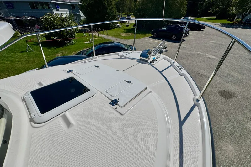  Yacht Photos Pics 2025 Ranger Tugs R-27 boat deck with railing and hatch, parked outdoors.