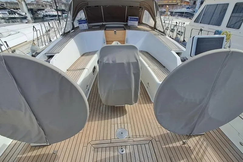  Yacht Photos Pics Cockpit of 2009 CNB BORDEAUX 60 yacht with covered steering wheels and wooden deck.