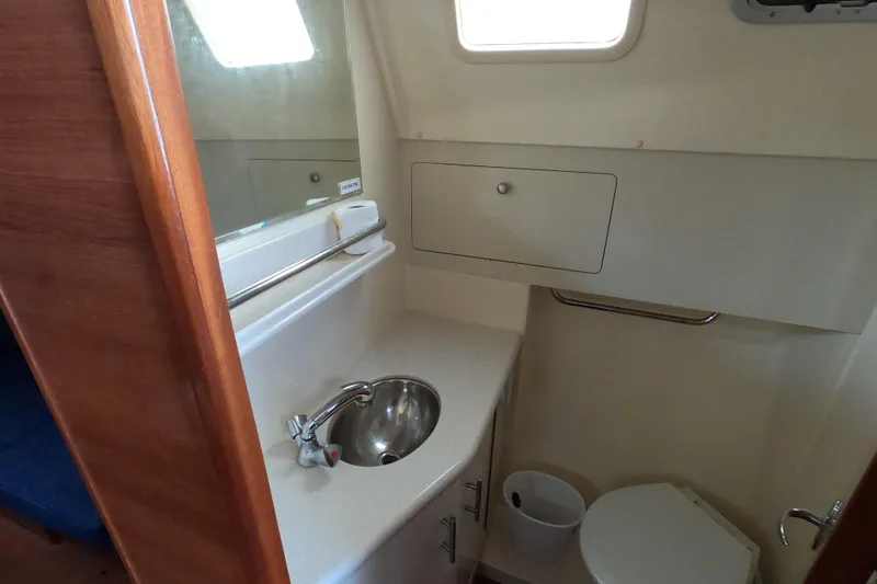 Moon Shadow Yacht Photos Pics 2013 Marlow-Hunter e33 yacht bathroom with sink, toilet, and storage cabinet.