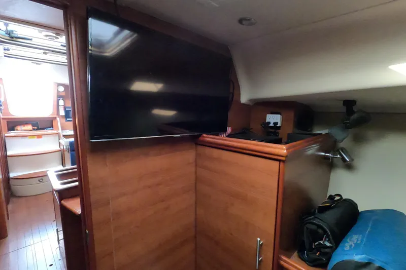 Moon Shadow Yacht Photos Pics Interior of 2013 Marlow-Hunter e33 sailboat with TV and wooden cabinetry.