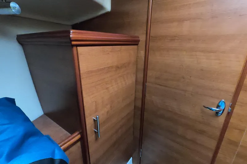 Moon Shadow Yacht Photos Pics Interior of 2013 Marlow-Hunter e33 sailboat with wooden cabinetry and door.