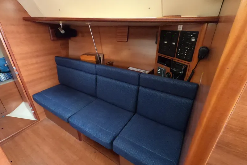 Moon Shadow Yacht Photos Pics Interior of 2013 Marlow-Hunter e33 sailboat with blue seating and control panel.