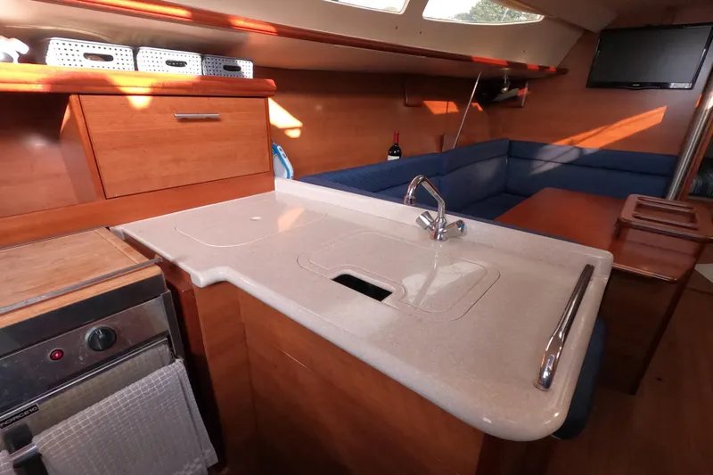 Moon Shadow Yacht Photos Pics Interior of 2013 Marlow-Hunter e33 sailboat with modern kitchen and seating area.