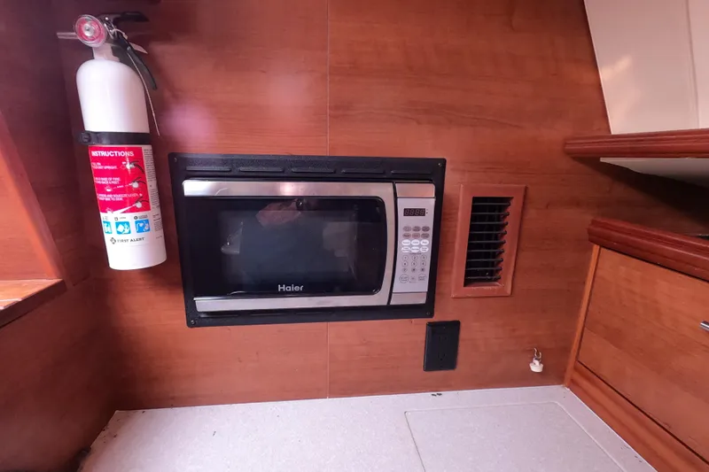 Moon Shadow Yacht Photos Pics Fire extinguisher and microwave in 2013 Marlow-Hunter e33 yacht interior kitchen.