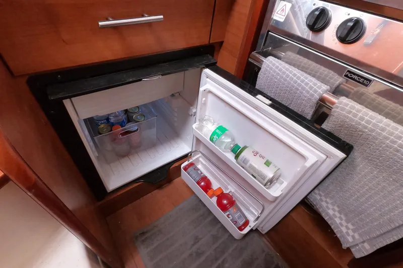 Moon Shadow Yacht Photos Pics Compact fridge in 2013 Marlow-Hunter e33 yacht galley, stocked with beverages.
