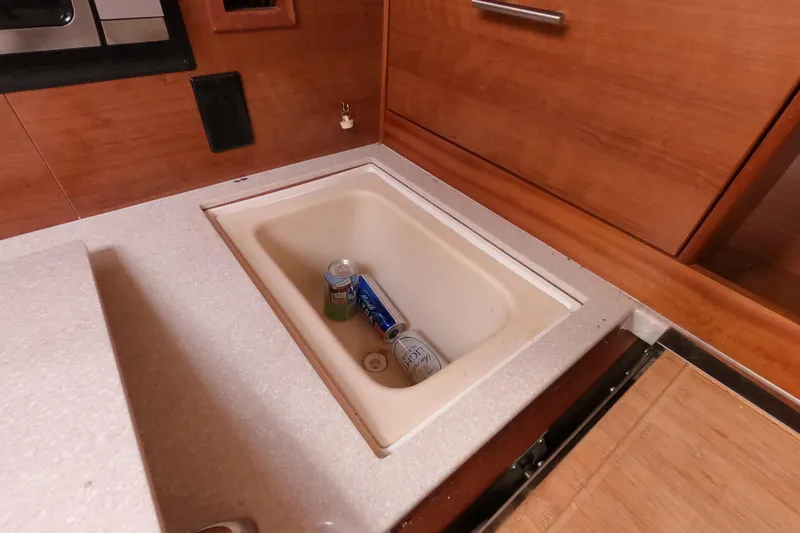 Moon Shadow Yacht Photos Pics 2013 Marlow-Hunter e33 interior with built-in cooler and beverage cans.