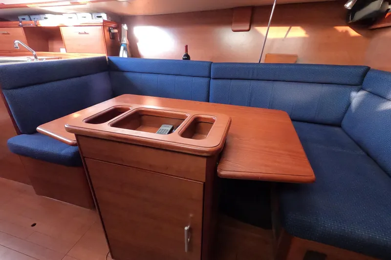 Moon Shadow Yacht Photos Pics 2013 Marlow-Hunter e33 yacht interior with blue seating and wooden table.