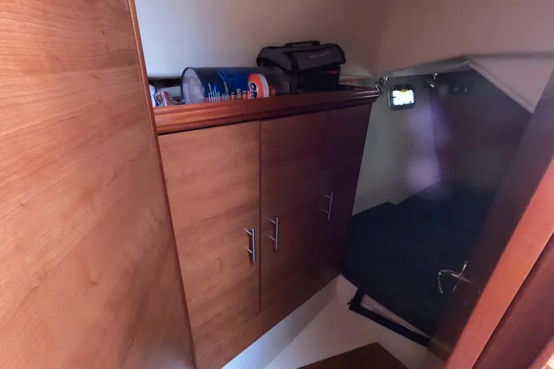 Moon Shadow Yacht Photos Pics 2013 Marlow-Hunter e33 cabin interior with wooden cabinets and cozy sleeping area.