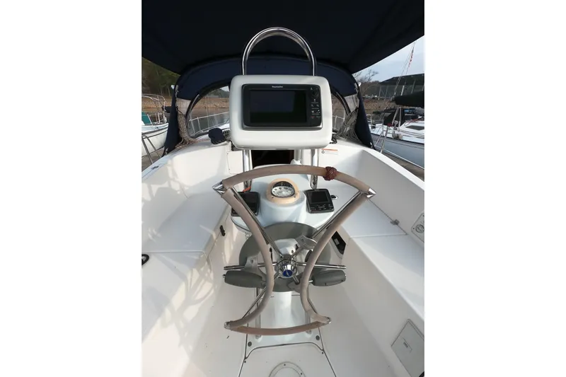 Moon Shadow Yacht Photos Pics 2013 Marlow-Hunter e33 sailboat cockpit with steering wheel and navigation equipment.