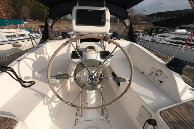 Moon Shadow Yacht Photos Pics 2013 Marlow-Hunter e33 sailboat cockpit with steering wheel and navigation equipment.