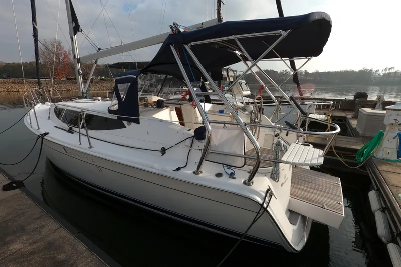 Moon Shadow Yacht Photos Pics 2013 Marlow-Hunter e33 sailboat docked at a marina, featuring sleek design and canopy.