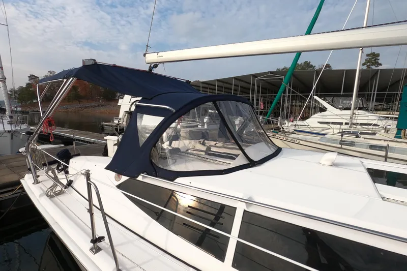 Moon Shadow Yacht Photos Pics 2013 Marlow-Hunter e33 sailboat docked with blue canopy and clear windows.