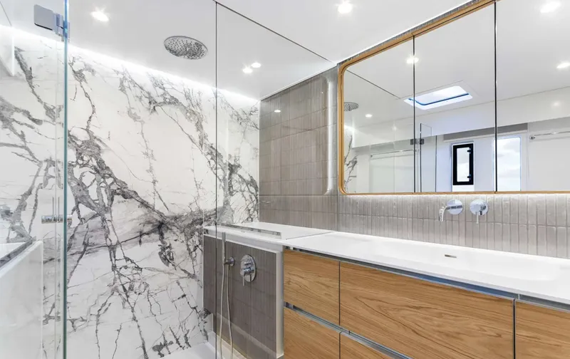  Yacht Photos Pics Luxurious bathroom in 2022 Sunreef 60 Sailing yacht with marble and wood finishes.