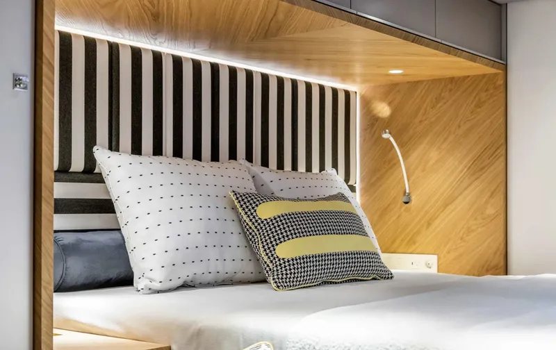  Yacht Photos Pics Luxurious Sunreef 60 Sailing 2022 yacht bedroom with modern design and cozy bedding.