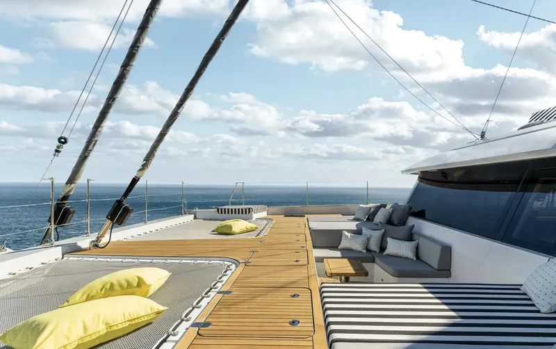  Yacht Photos Pics Luxurious Sunreef 60 Sailing yacht deck with cushions, ocean view, and clear skies, 2022 model.