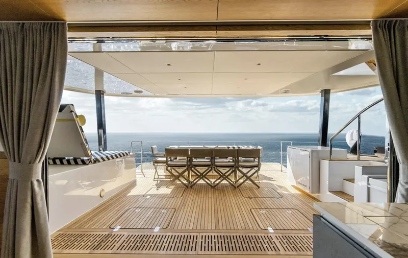  Yacht Photos Pics Luxurious Sunreef 60 Sailing yacht deck with ocean view, featuring elegant seating and modern design.