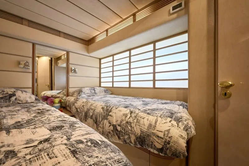  Yacht Photos Pics Luxurious cabin interior of 1992 Posillipo Technema 82 yacht with twin beds and modern decor.