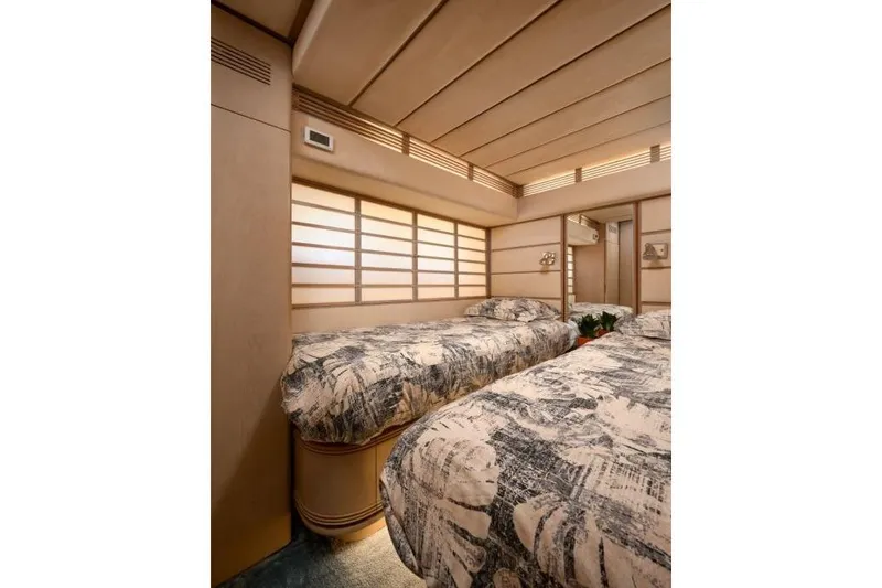  Yacht Photos Pics Luxurious twin bedroom in 1992 Posillipo Technema 82 yacht, featuring elegant decor and cozy bedding.