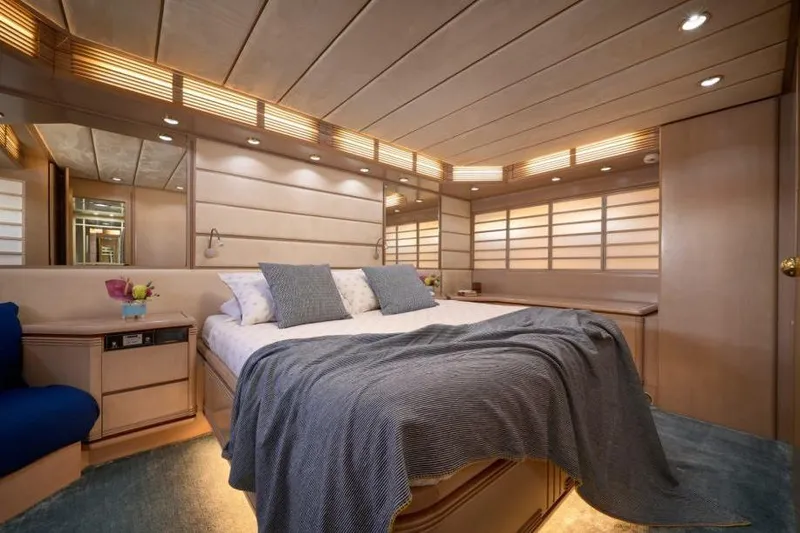  Yacht Photos Pics Luxurious bedroom interior of 1992 Posillipo Technema 82 yacht with elegant wood paneling.