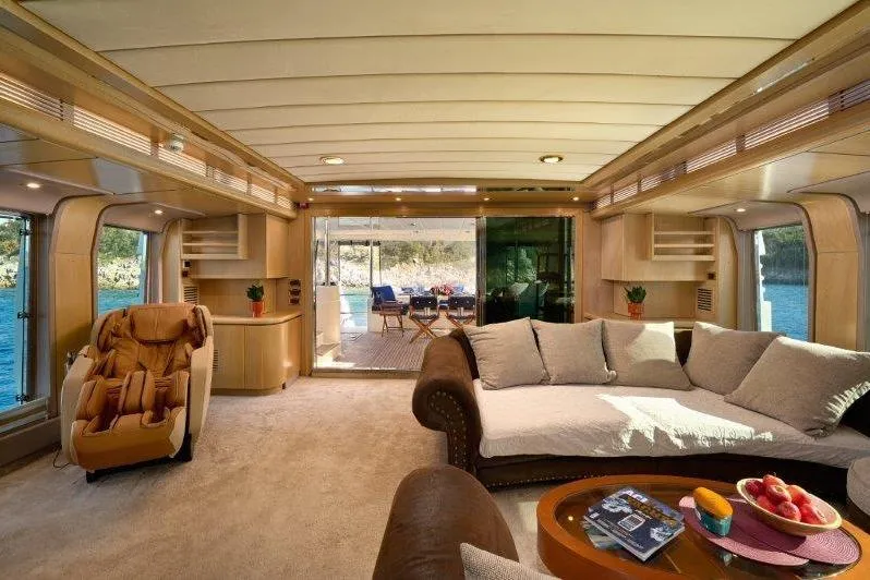  Yacht Photos Pics Luxurious interior of 1992 Posillipo Technema 82 yacht with plush seating and scenic views.